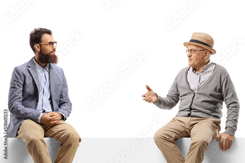 Elderly and younger man sitting on a panel and having a talk