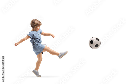 Full length shot of a little girl kicking a football
