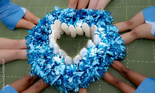 фотографія Cheerleaders Forming a Pompom Heart