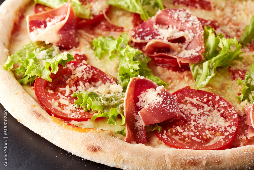 Pizza with prosciutto, lettuce salad and parmesan. Pizza with prosciutto, lettuce salad and parmesan.