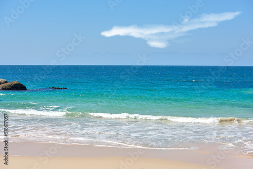Calm beach with white sand by a natural seaside environment in a popular getaway location for a holiday in Cape town. Landscape of the ocean on a sunny day with blue sky and copy space