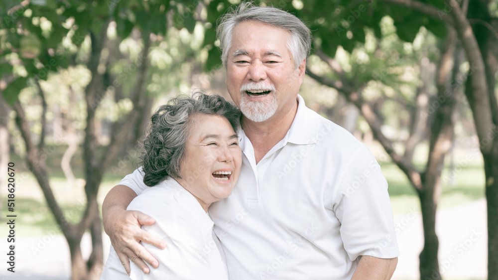 Happy love Elderly couple smile face , Senior couple old man and senior woman relaxing hug in a forest