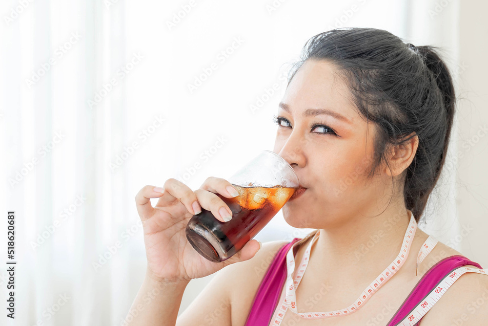 Portrait beautiful plump young Asian woman joy of eating drinking cola , Sweet water , sparkling water on bedroom reason why you are fat - lifestyle Woman diet weight loss overweigh Portrait beautiful plump young Asian woman joy of eating drinking cola , Sweet water , sparkling water on bedroom reason why you are fat - lifestyle Woman diet weight loss overweigh