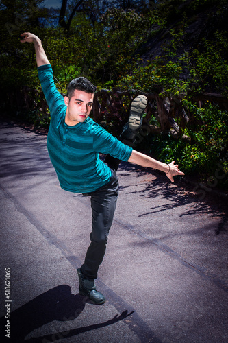 Obraz na płótnie Dancing in Park. Young man, stretching arms, legs, dancing in park in New York City. w salonie