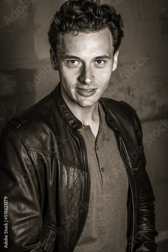 Obraz na płótnie Portrait of Young Man in New York City. Young man wearing black leather jacket, charmingly looking forward. Black and White Photography w salonie