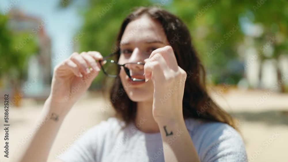 Young woman smiling confident wearing glasses at park