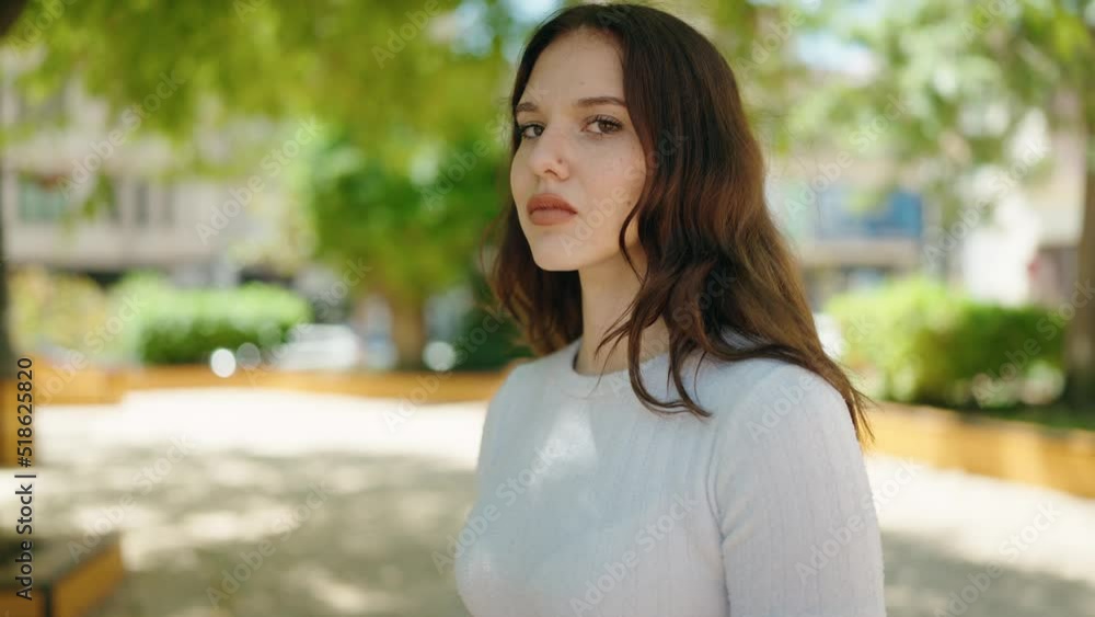 Young woman with relaxed expression standing at park Young woman with relaxed expression standing at park