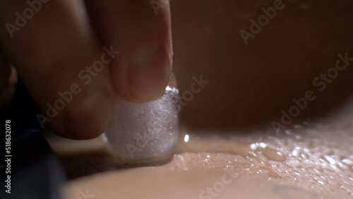 Ice on skin close up,seduction foreplay in bedroom photo