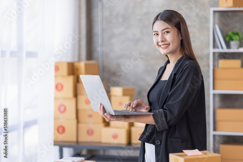 Portrait of young Asian woman SME working with a box at home the workplace.start-up small business owner, small business entrepreneur SME or freelance business online and delivery concept.