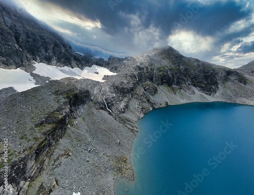 Beautiful glaciered mountain with a lake in Norway photo