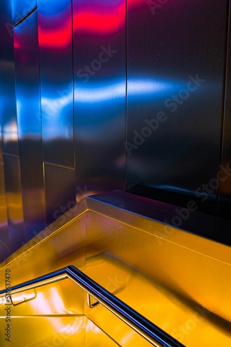 Canvastavla Vertical shot of a modern stair handrail hallway with metal walls reflecting col