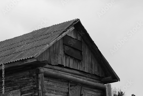 Grayscale shot of the top of  film old abandoned house in a rural areaa photo