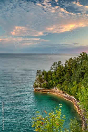 Vertical shot of a cloudy sunrise at Miners Castle in Pictured Rocks National Lakeshore, Michigan photo