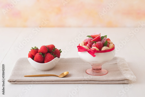 Charlotte, French dessert with strawberries tied up with a scarlet ribbon, easy and fast dessert made into a glass. Low angle view, no people.