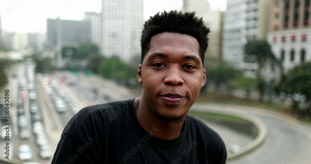 Portrait young black mixed race man standing in downtown city Portrait young black mixed race man standing in downtown city
