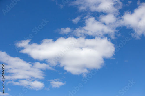 Blue sky with typical scattered white clouds in selective focus