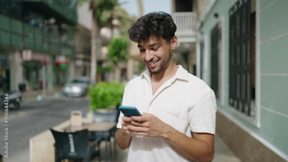 Young arab man smiling confident using smartphone at street Young arab man smiling confident using smartphone at street