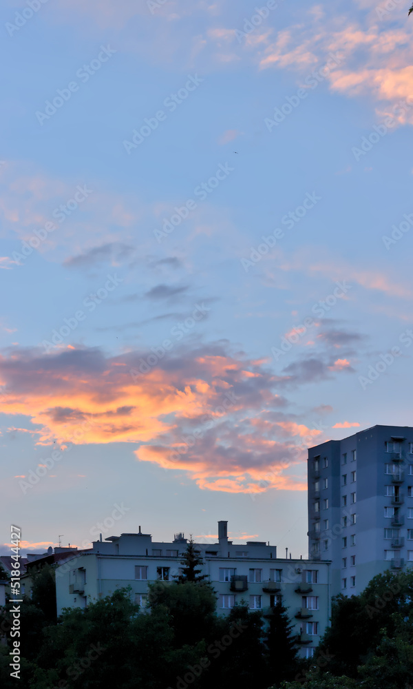 Fototapeta premium Residential building against the setting sun.