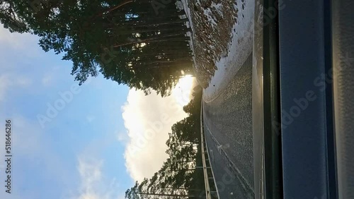 4k Vertical PoV footage from a car going through a snow mountain at sunrise