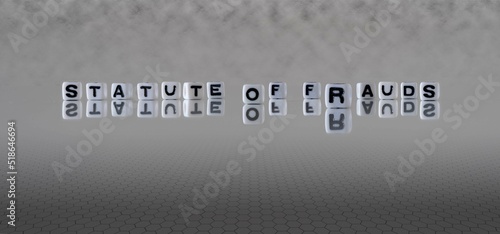 statute of frauds word or concept represented by black and white letter cubes on a grey horizon background stretching to infinity photo
