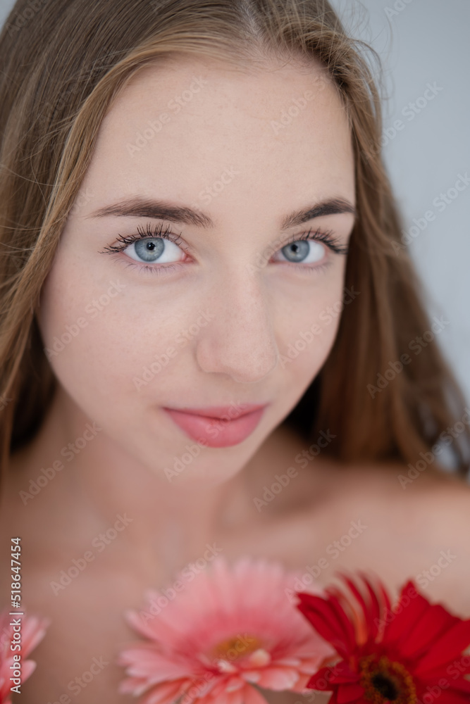 Portrait of pretty young woman with pink and red chrysanthemum flowers Portrait of pretty young woman with pink and red chrysanthemum flowers