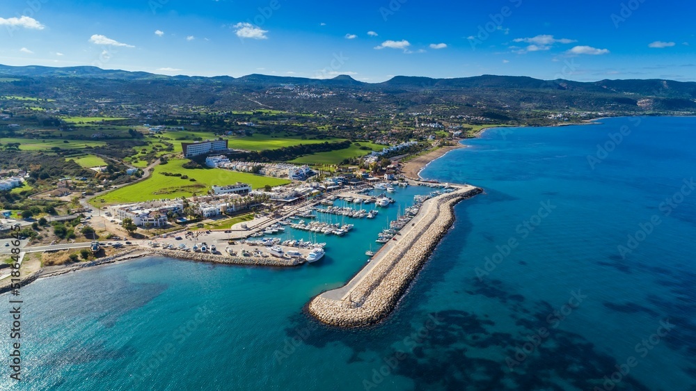 Aerial bird's eye view of Latchi port, Akamas peninsula, Polis Chrysochous, Paphos,Cyprus. Latsi harbour with boats and yachts, fish restaurant, promenade, beach tourist area and mountains from above