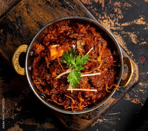 Mutton Sukka karahi served in a dish isolated on dark background top view