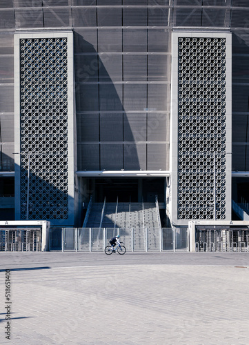 Vertical shot of a biker with Ferenc Puskas Stadium on the background in Hungary photo