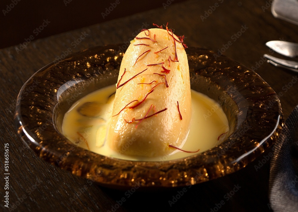 Pakistani Ras Ras Malai served in a dish isolated on dark background side view of ...