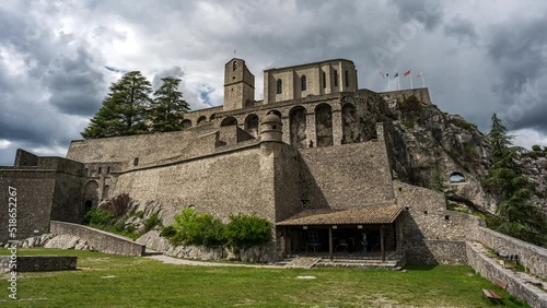 Time lapse footage of the Citadelle de Sisteron in France inder a gloomy sky photo