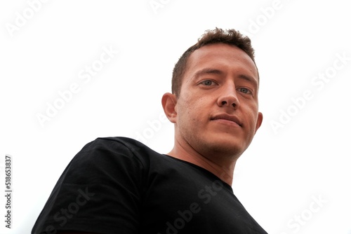 Εκτύπωση καμβά Low angle portrait of a hispanic man isolated on a whit background