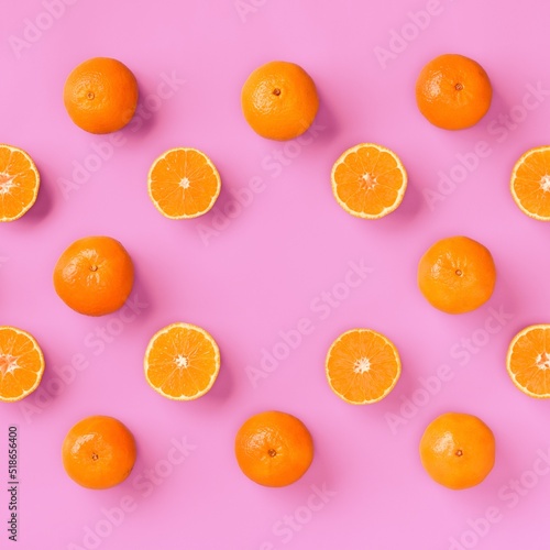 Fruit pattern of tangerine or mandarin on pink background. Flat lay, top view.