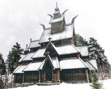 Low-angle shot of Gol Stave Church covered in snow during winter in Gol, Norway