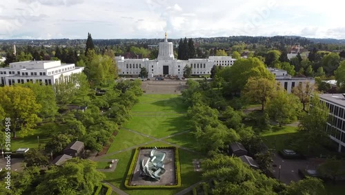 Aerial drone footage of the Oregon State Capitol in Salem with a vast green park with greenery photo