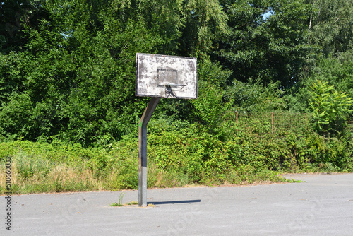 Old basketball hoop on a sunny summer day.