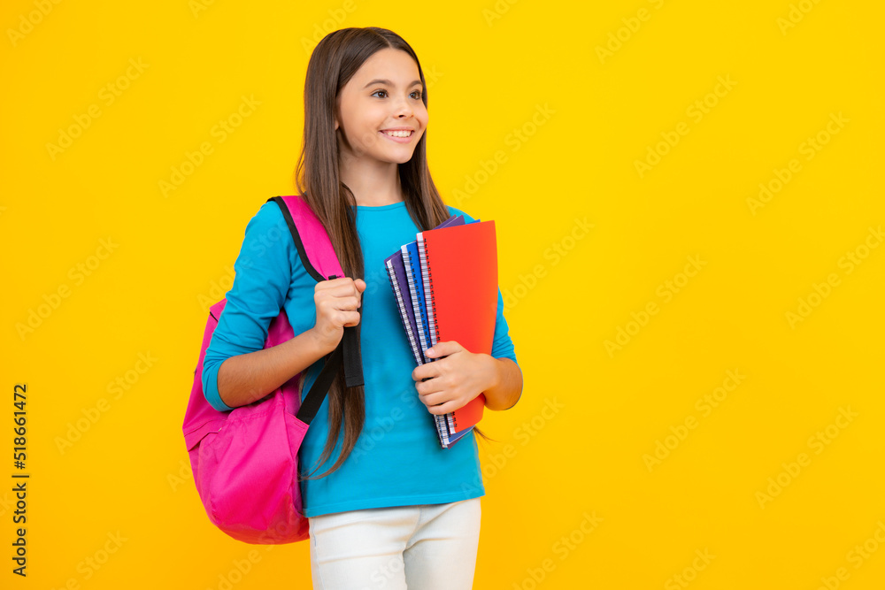Happy teenager portrait. School teenager child girl 12, 13, 14 years old with book and copybook. Teenager schoolgirl on isolated background. Learning and knowledge education concept. Smiling girl. Happy teenager portrait. School teenager child girl 12, 13, 14 years old with book and copybook. Teenager schoolgirl on isolated background. Learning and knowledge education concept. Smiling girl.