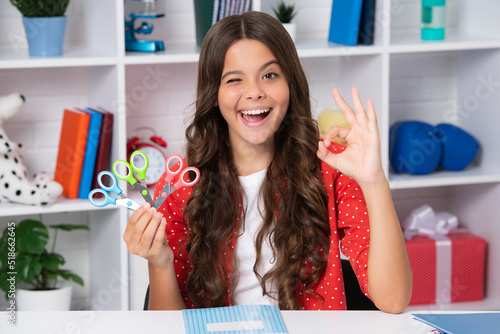 Teen girl with scissors. Diy Ideas for children. Love and child art hobby concept. Excited face, cheerful emotions of teenager school girl.
