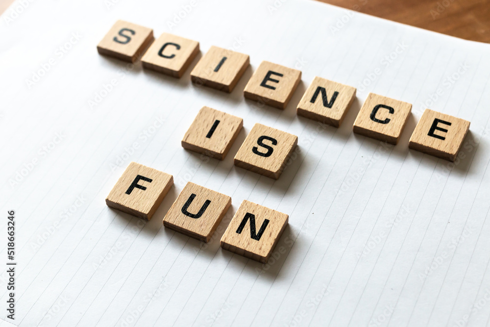 Wooden letters spell out 'science is fun' on a blank white lined notepad. Hardwood desk surface. Back to school, in-person learning, online learning, studying, no people, studies, primary school. Wooden letters spell out 'science is fun' on a blank white lined notepad. Hardwood desk surface. Back to school, in-person learning, online learning, studying, no people, studies, primary school.