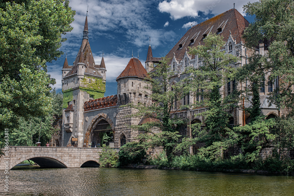 Historical building in Budapest - Vajdahunyad Castle with lake over the blue sky in main City Park.