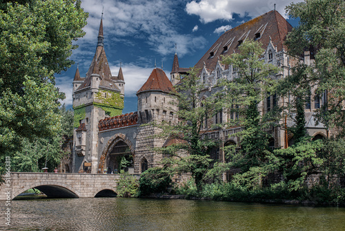 Historical building in Budapest - Vajdahunyad Castle with lake over the blue sky in main City Park.