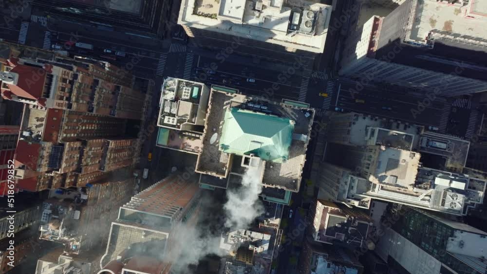 Aerial birds eye overhead top down ascending shot of smoking chimney on roof of historic buildings in town development. Manhattan, New York City, USA Aerial birds eye overhead top down ascending shot of smoking chimney on roof of historic buildings in town development. Manhattan, New York City, USA