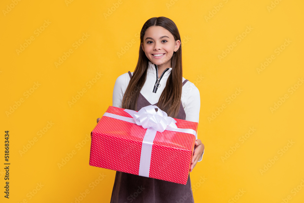 smiling child with present box on yellow background smiling child with present box on yellow background