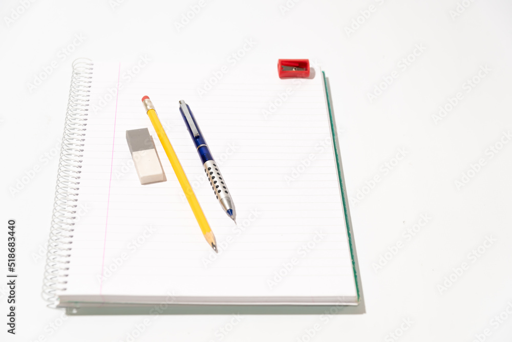 school equipment on blank notebook school equipment on blank notebook