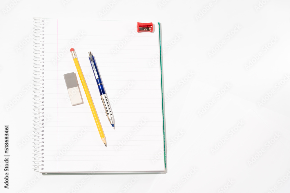 school equipment on blank notebook school equipment on blank notebook