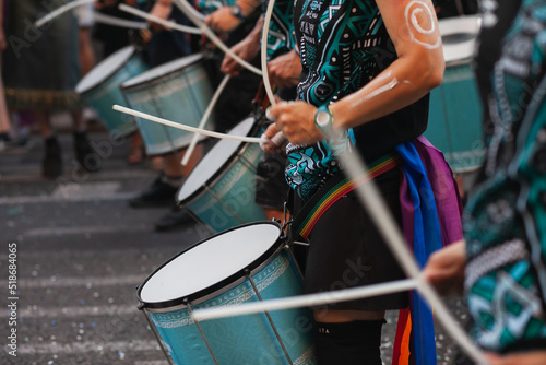 Music band playing drums in the street at public event. Drummers musicians playing music at Pride festival in June. Pride month march celebration. Queer lgbt community awareness.