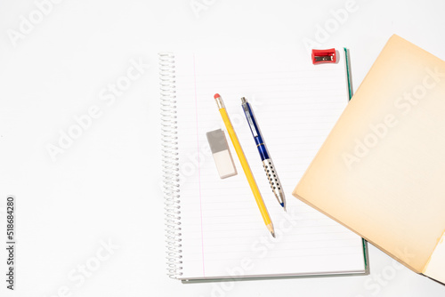 school equipment on blank notebook