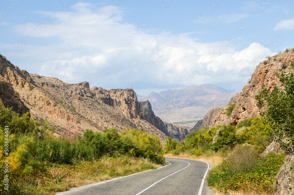 Image of an asphalt road leading through the mountain gorge of the Caucasus Mountains of Armenia