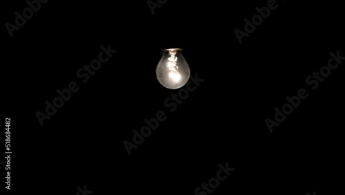 Wallpaper Mural Lonely ordinary electric lamp hanging and swinging in the dark. Torontodigital.ca