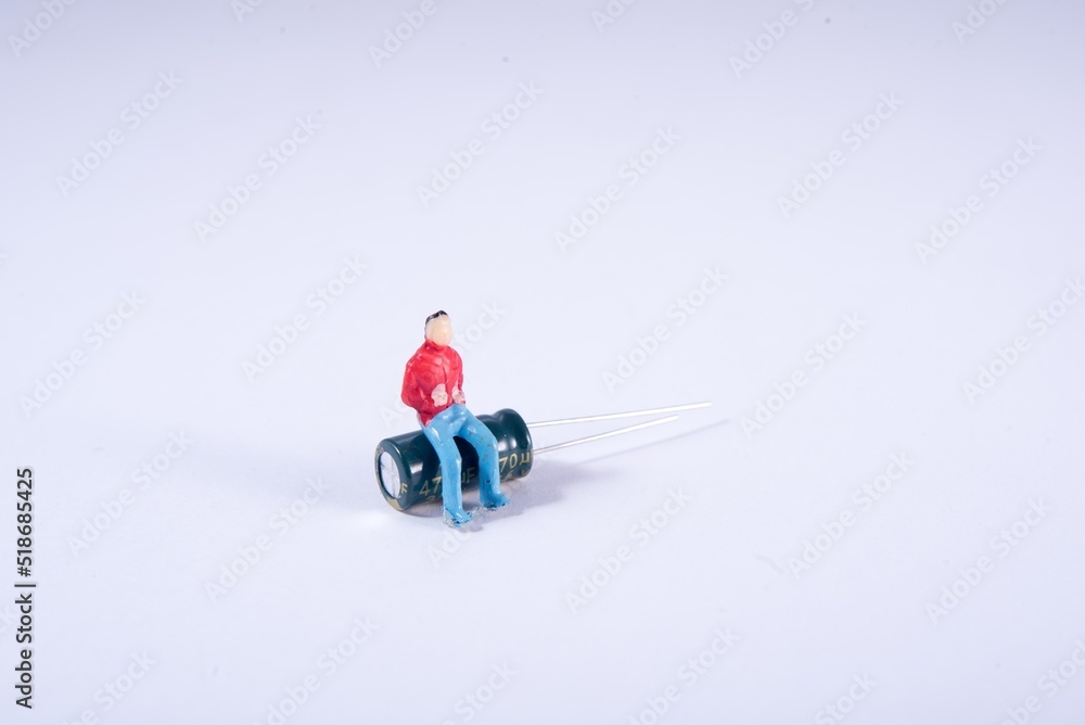 Man sitting on technology. Diorama. Energy. Condenser. Energy accumulator. Energy recharging. Diorama. Man sitting on technology. Diorama. Energy. Condenser. Energy accumulator. Energy recharging. Diorama.
