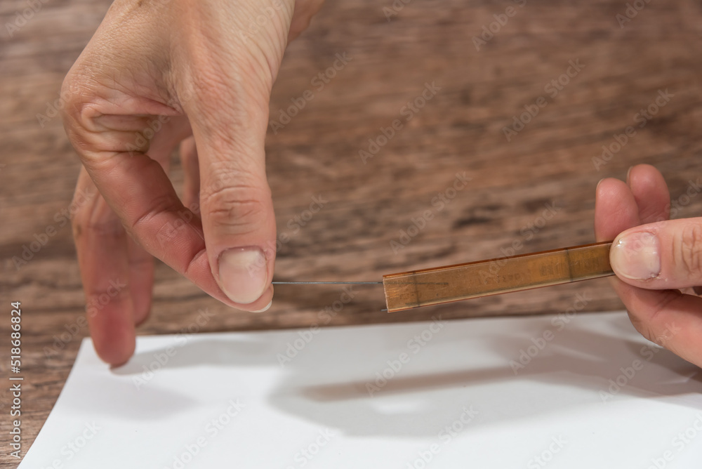hand placing a graphite mine in its box hand placing a graphite mine in its box